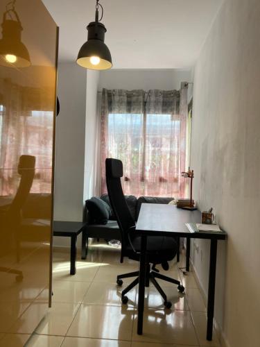 a dining room with a table and chairs and a mirror at Remote work Family holiday apartment in Alcalá