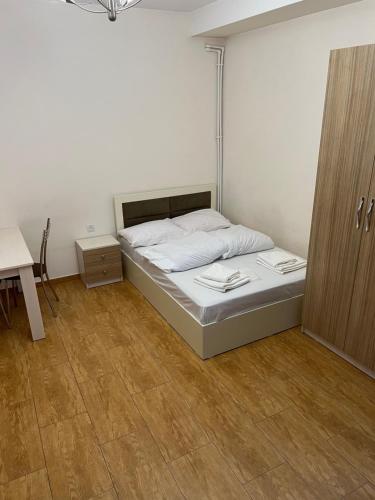 a bedroom with a bed and a wooden floor at Cozy holiday home in Yerevan