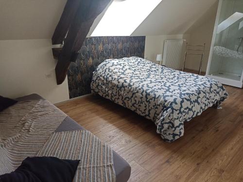 a bedroom with two beds and a wooden floor at La Bruyère - B & B - in Tréban
