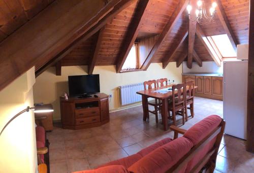 a living room with a couch and a dining room table at Casa Valentí in Taull