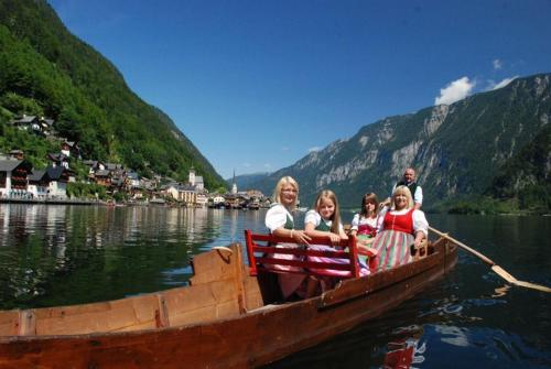 a group of people sitting on a boat in the water at Appartement Traumblick mit Indoorpool und privater Sauna in Bad Goisern