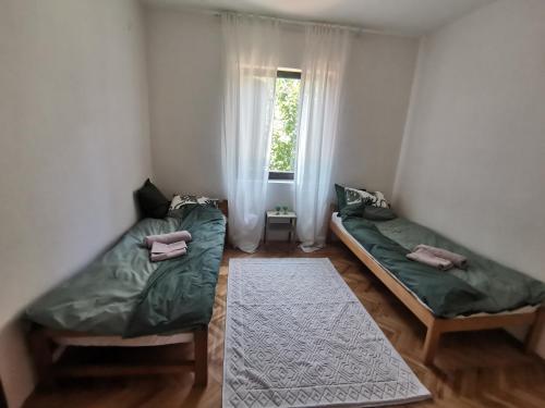 a room with two beds and a window at Park 1 MARKO FREE PARKING in Vranje
