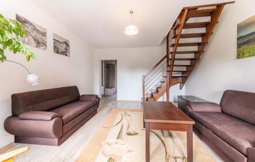 a living room with two brown couches and a wooden table at Apartament rodzinny in Solina