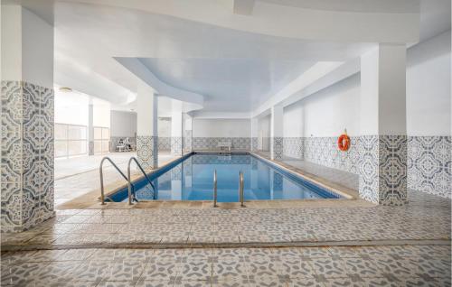 a pool in a building with a tile floor at Awesome Apartment In Puerto De La Cruz in Puerto de la Cruz