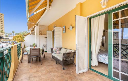 a balcony with a bed and a table and chairs at Awesome Apartment In Puerto De La Cruz in Puerto de la Cruz