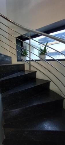 a staircase with two potted plants in a building at Eka Homes 3BHDK Villa in Trivandrum