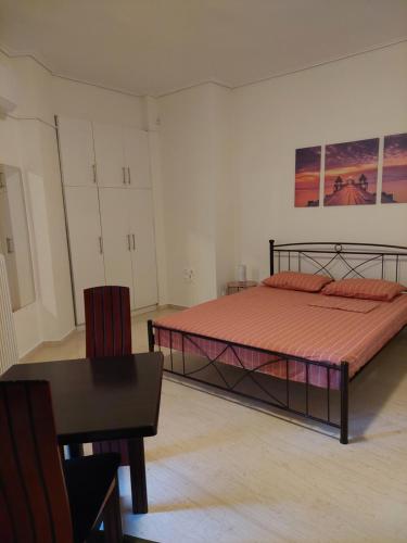 a bedroom with a bed and a table and a chair at PlazaVerrosA6Room in Tripoli