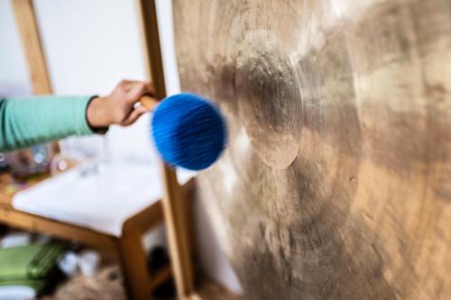 a person painting a wooden wall with a brush at Der Winzerhof in Achau