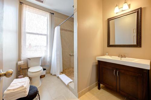 a bathroom with a sink and a toilet and a mirror at Wellington Street Inn by Hoco Hotels Collection in Stratford