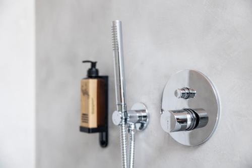 a bathroom with a shower with a fire extinguisher at Casa Da Avó Clementina Nº 30 in Funchal