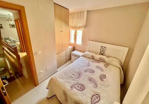 a small bedroom with a bed and a window at La casita de la abuela María in Navalacruz