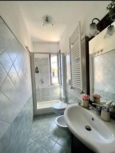 a bathroom with a sink and a toilet at Civico 22 in Fiumicino