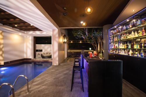 a nightclub with a pool and a bar at De Chai Colonial Hotel & Spa in Chiang Mai