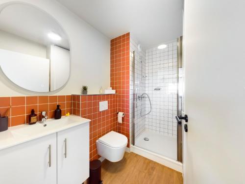 a bathroom with a shower and a toilet and a sink at Hife Toulouse Sud Labège in Labège