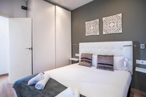 a bedroom with a large white bed with two pillows at S2SEP498 - Great apartment with private terrace in Barcelona