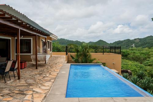 a swimming pool in the backyard of a house at Exquisite Private Coastal Retreat home in San Juan del Sur