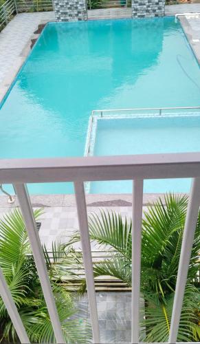 a swimming pool with a table and a blue pool at Sky Lawns in Lonavala