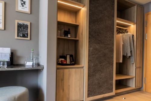 a closet in a room with wooden cabinets at Schwarzwald Panorama in Bad Herrenalb
