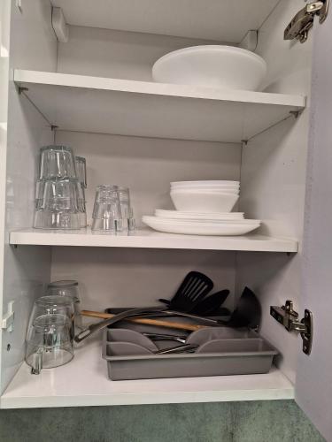 a kitchen shelf with plates and dishes on it at Mooie studio 14 C in center in Rotterdam