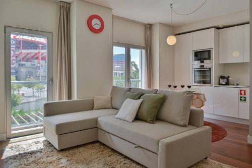 a living room with a couch and a kitchen at Ola Lisbon - Benfica in Lisbon