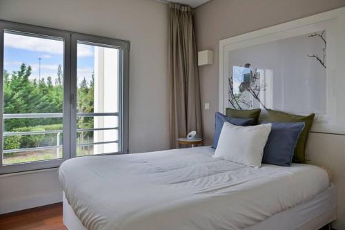 a bedroom with a large bed with a large window at Ola Lisbon - Benfica in Lisbon