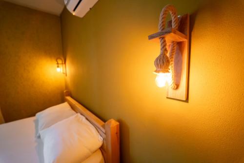 a bedroom with a bed and a cross on the wall at Sea Smelling Boutique Hotel in Kemer