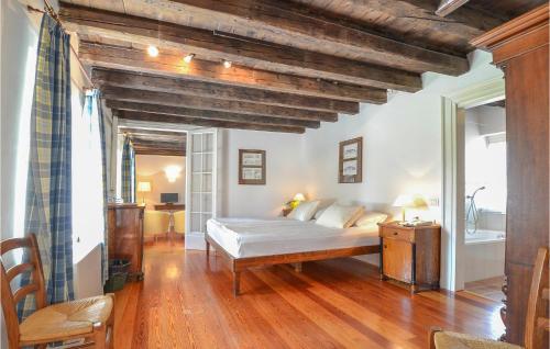 a bedroom with a bed in a room with wooden ceilings at Casa Orange in Tissano