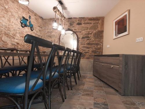 a dining room with a table and some chairs at As Seis Chemineas in San Xulián de Sales