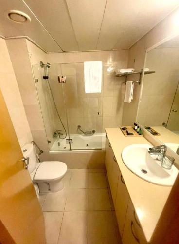 a bathroom with a toilet and a shower and a sink at Okeanos Bmarina in Herzliya B