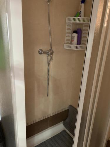 a shower stall in a bathroom with a chair at CASA ALICIA in Torre del Mar