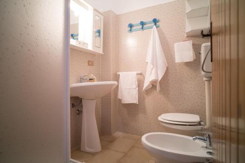La petite salle de bains est pourvue d'un lavabo et de toilettes. dans l'établissement Monolocale ilporticciolovacanze, à Villanova di Ostuni