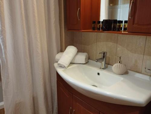 a bathroom with a sink and a shower curtain at Istamos apartment in Stamnoí