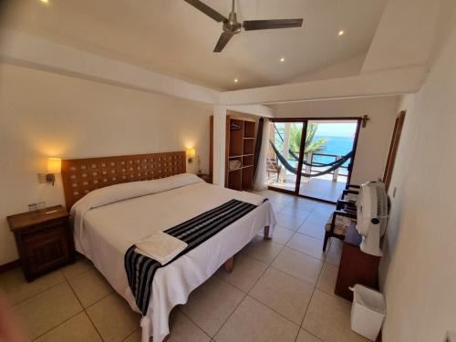 um quarto com uma cama e vista para o oceano em Posada Ziga Playa em Mazunte