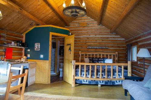 a kitchen with wooden walls and a wooden ceiling at Jasper Gates Resort in Jasper