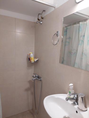 a bathroom with a shower and a sink and a mirror at PlazaVerrosA6Room in Tripoli
