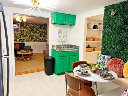 uma cozinha com armários verdes e uma mesa num quarto em Secret Garden Denver em Denver