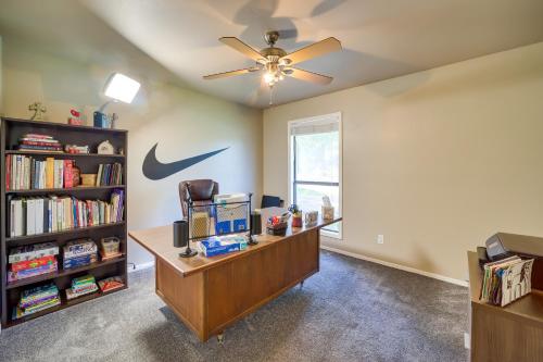 a office with a desk and a ceiling fan at Spacious Arkansas Abode with Balcony and Fire Pit! in Fort Smith