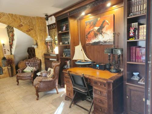 a home office with a desk and a tv at British Wood 'n Stone House in Thessaloniki