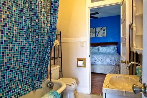 a bathroom with a blue tiled shower and a bed at Clarkdale Lodge 208 in Clarkdale