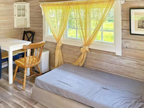 Schlafzimmer mit einem Bett, einem Schreibtisch und einem Fenster in der Unterkunft Holiday home ÅKERSBERGA V in Åkersberga