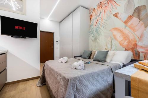 a bedroom with a bed with towels on it at Exotic House in central of Milan in Milan