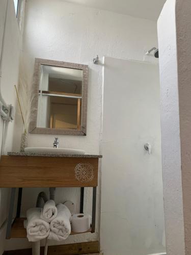 a bathroom with a sink and a mirror and towels at Hotel Casa Lucca in Medellín