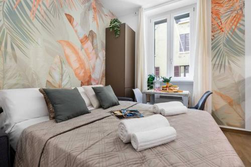 a bedroom with a large bed with two pillows at Exotic House in central of Milan in Milan