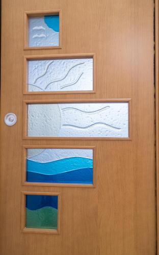 a wooden door with two windows on it at Mareterè in Vietri sul Mare