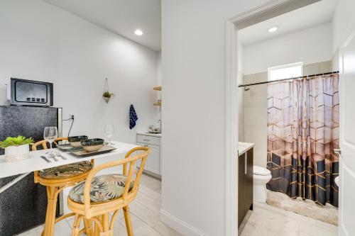 a kitchen with a table and chairs and a shower at 3 Mi to Lakefront Beach St Cloud Apt in Ashton