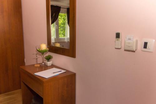 a room with a desk with a mirror and a candle at Villa Petra in Međugorje