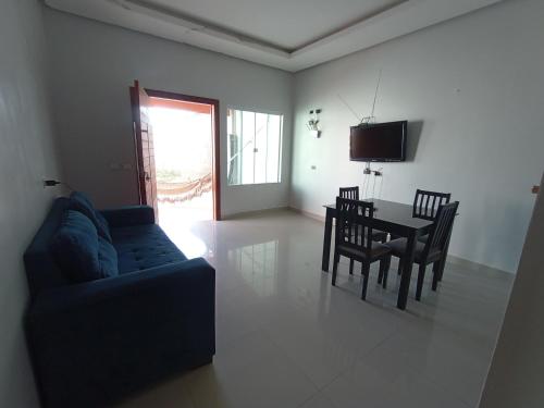 a living room with a couch and a table and chairs at Residência em Bairro Nobre in Imperatriz