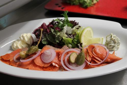 a plate of food with a salad on a table at Hotel Kernen in Gstaad