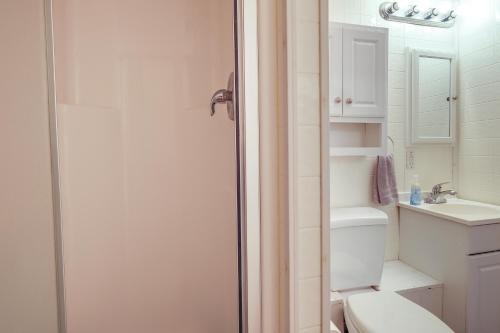 a white bathroom with a toilet and a sink at Cozy Hiwassee Vacation Rental with Yard in Hiwassee