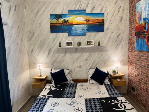 a bedroom with two beds and a painting on the wall at Holiday Appartment Elbe in Lomé